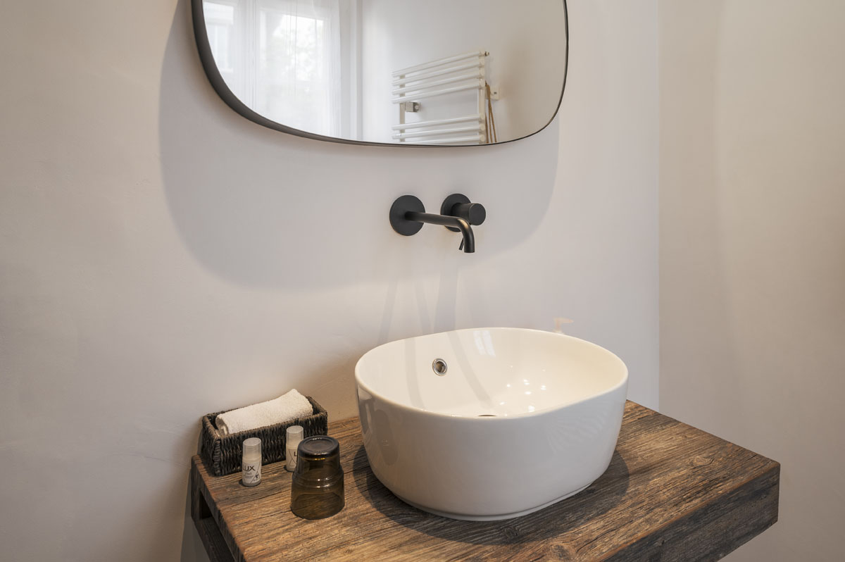 Designer bathroom with vessel sink at Amanthos Living